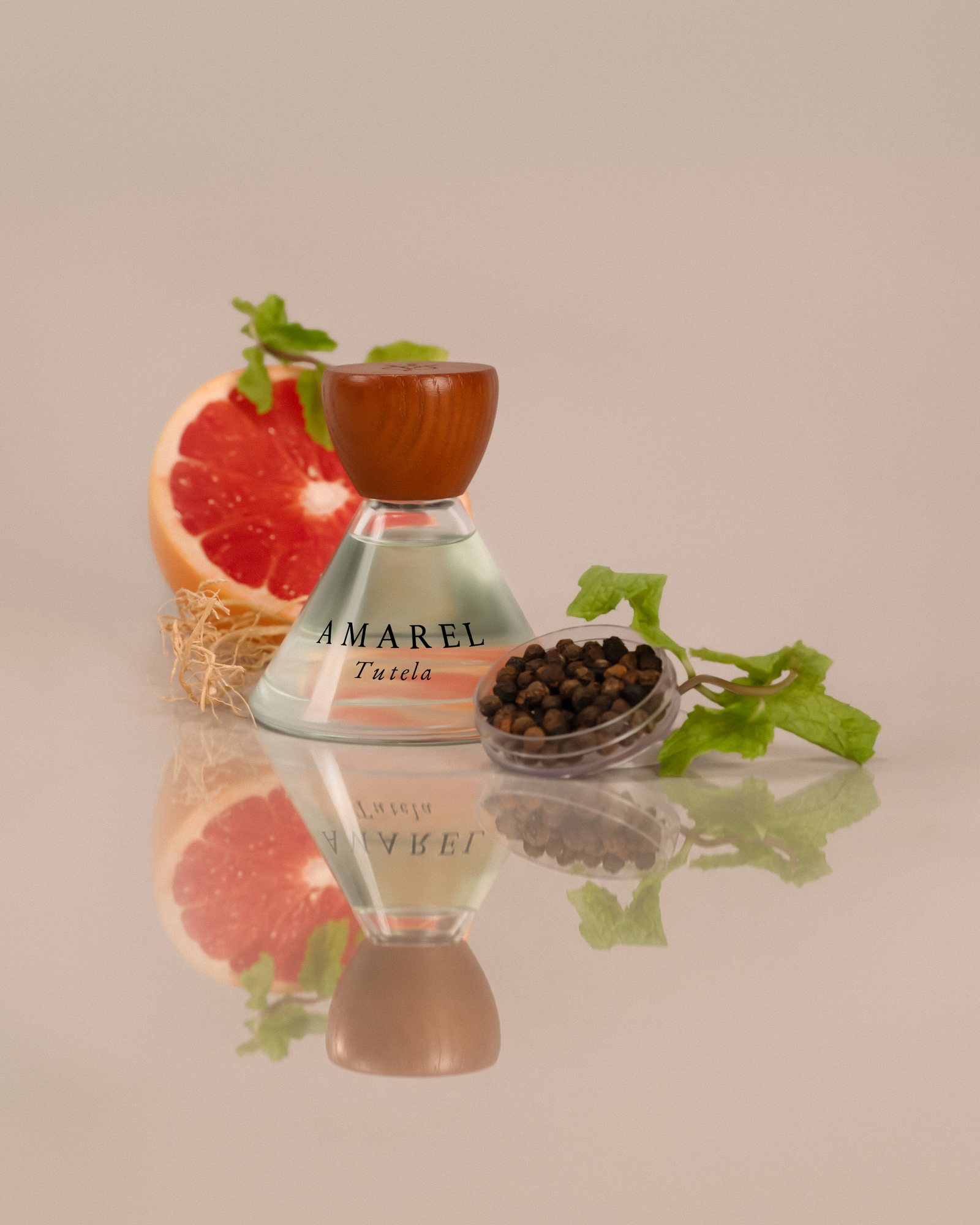 Tutela 00 standing on a mirror with grapefruit, mint, vetiver root and black pepper, on warm grey